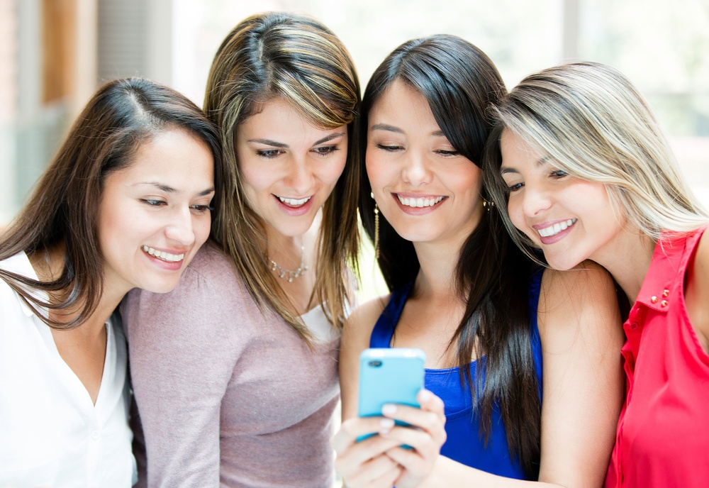 Group of girls looking at a cell phone.jpeg